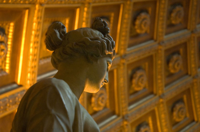The head of a statue, lit from below.