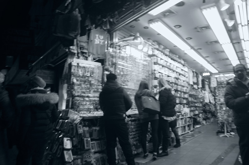 Shoppers looking at accessories in a small store